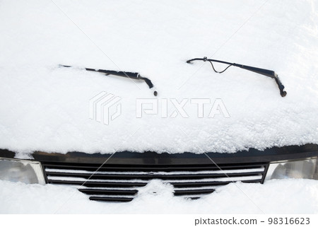 Car wipers and windscreen covered with snow Car wipers and windscreen covered with snow 98316623
