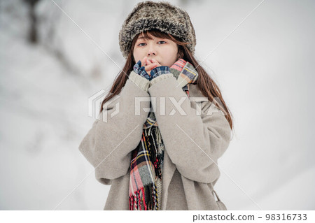 A woman enjoying innocently in a snowy winter landscape 98316733