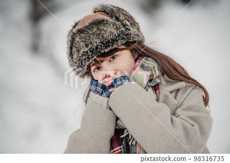 A woman enjoying innocently in a snowy winter landscape A woman enjoying innocently in a snowy winter landscape 98316735