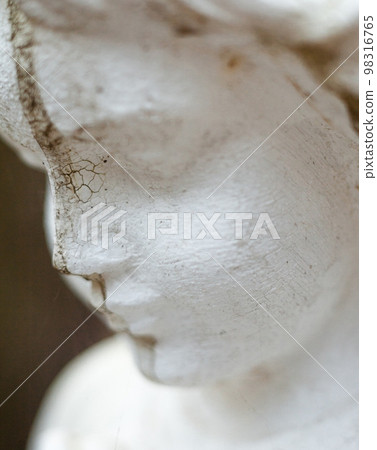 Old sculpture of the young girl. 98316765