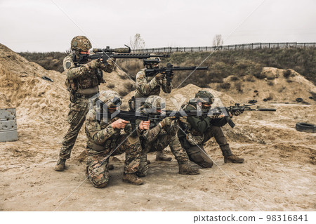 Group of soldiers in camouflage with rifles in hands 98316841