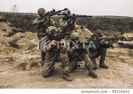 Group of soldiers in camouflage with rifles in hands 98316842