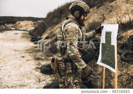 Soldier in camouflage having shooting training 98316883
