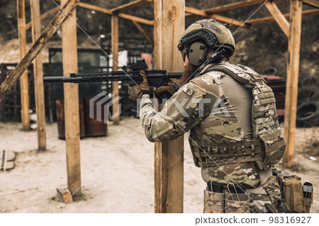 Soldier in camouflage with a rifle in hands 98316927