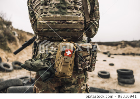 Backside picture of a soldier in camouflage Backside picture of a soldier in camouflage 98316941