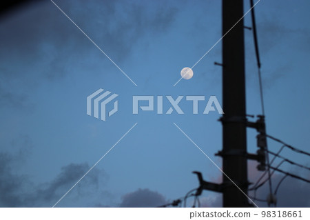 moon rising over the city at dusk moon rising over the city at dusk 98318661