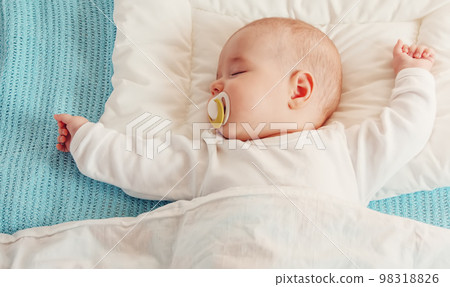 Cute three month old baby sleeping in comfortable bed. Cute three month old baby sleeping in comfortable bed. 98318826