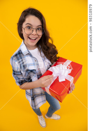 amazed teen kid in glasses with present. studio shot of teen kid hold present. teen kid holding box 98318979