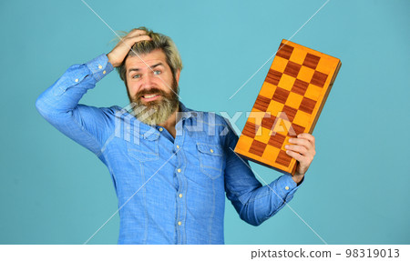 Exercise for brain. Chess figures. Intellectual games. Intelligent bearded hipster. Cognitive skills. Game strategy concept. Chess lesson. Teacher chess competition. Board game. Man playing chess Exercise for brain. Chess figures. Intellectual games. Intelligent bearded hipster. Cognitive skills. Game strategy concept. Chess lesson. Teacher chess competition. Board game. Man playing chess 98319013