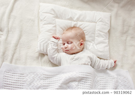 Cute five month old baby sleeping in comfortable bed. 98319062