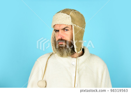 Bearded hipster. Winter fashion. Warm hat for cold weather. Beard care for winter season. Facial hair concept. Barber services. Bearded man wear hat with ear flaps. Furry accessory. Fur garments 98319563