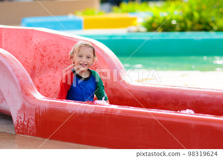 Kids on water slide in aqua park. Summer vacation 98319624