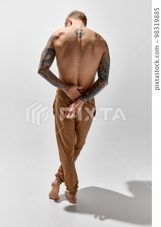 Portrait of young 30 years old man posing shirtless. Perfect muscular body shape. Tattoo body art. Concept of fashion, style, body aesthetics, beauty, men's health 98319885