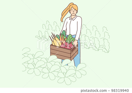 Smiling woman with box of vegetables  98319940