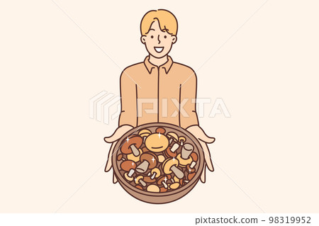 Smiling man hold bowl with mushrooms 98319952