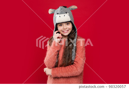earflap hat knitwear. smiling teen child model in earflap hat. teen child in earflap hat 98320057