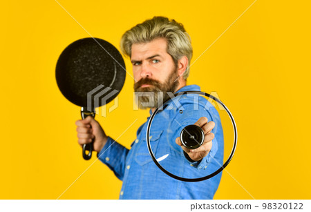Cooking healthy food. Bearded hipster preparing breakfast. Frying tips. Shopping kitchenware. Cooking utensils. Enameled cast iron cooking vessels. Nonstick pan porcelain surface. Man hold new pan Cooking healthy food. Bearded hipster preparing breakfast. Frying tips. Shopping kitchenware. Cooking utensils. Enameled cast iron cooking vessels. Nonstick pan porcelain surface. Man hold new pan 98320122