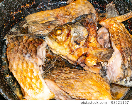 Fish crucian carp is fried in a pan. Fish crucian carp is fried in a pan. 98321167
