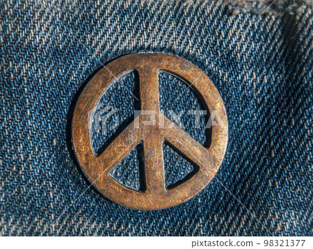 Iron sign of a pacifist on denim. 98321377