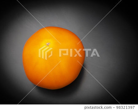 Yellow tomatoes vegetables on a black background. 98321397