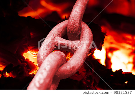 Iron chain links heated by a furnace fire. Iron chain links heated by a furnace fire. 98321587