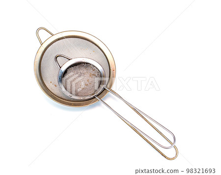 Metal strainer for coffee and tea on a white background. Metal strainer for coffee and tea on a white background. 98321693