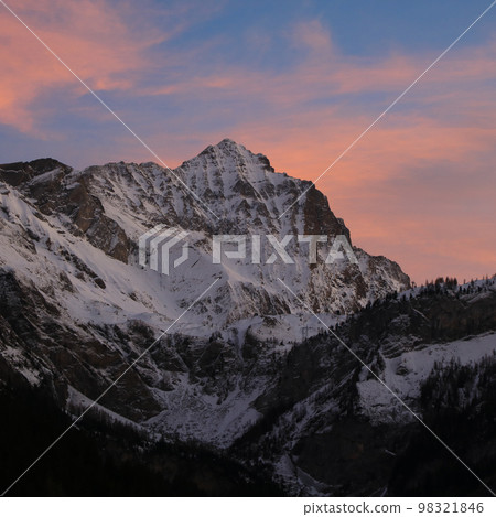Sunlit pink clouds over Mount Arpelistock in winter. Sunlit pink clouds over Mount Arpelistock in winter. 98321846