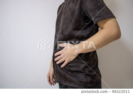 A man in exercise clothes who cares about his stomach A man in exercise clothes who cares about his stomach 98322011