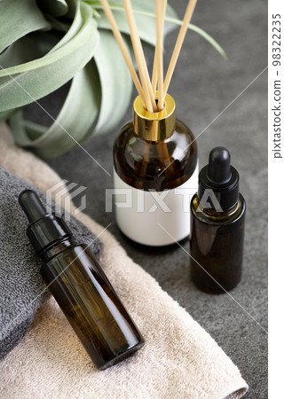Blackout bottle with aroma diffuser and cosmetics on towel 98322235