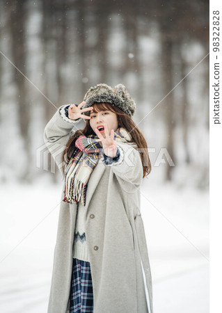 A woman having fun in the snowy mountains A woman having fun in the snowy mountains 98322828