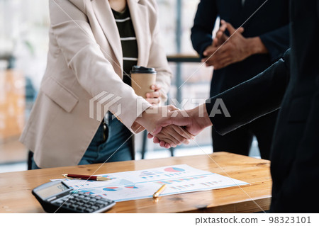 Business people shaking hands, finishing up meeting, business etiquette, congratulation, merger and acquisition concept Business people shaking hands, finishing up meeting, business etiquette, congratulation, merger and acquisition concept 98323101