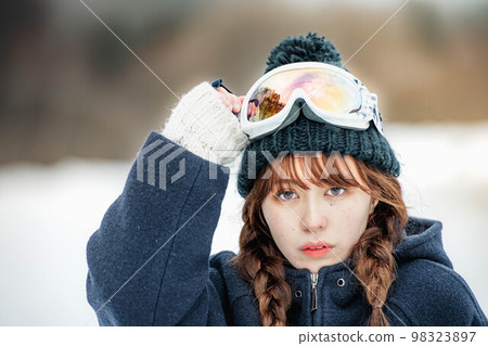 Woman enjoying winter sports at a ski resort 98323897