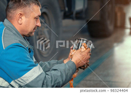 Auto mechanic repairs truck. Professional repair and diagnostics of cargo tractors and equipment 98324404