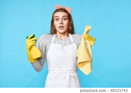 woman in gloves and cleaner apron with cleaning rag and detergent sprayer woman in gloves and cleaner apron with cleaning rag and detergent sprayer 98325743