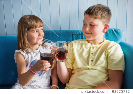 Children with cold, refreshing drinks in their hands. Soft drink 98325782