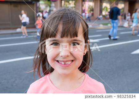 Beautiful little girl eats ice-cream in the summer Beautiful little girl eats ice-cream in the summer 98325834