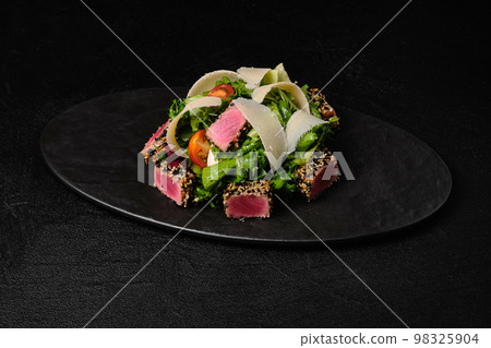 Tuna salad with parmesan on black plate Tuna salad with parmesan on black plate 98325904