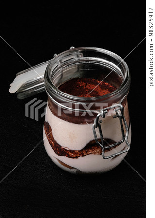 Classic Italian tiramisu dessert served in a jar 98325912