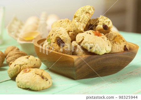 Homemade oatmeal cookies with candied fruit in a heart-shaped plate Homemade oatmeal cookies with candied fruit in a heart-shaped plate 98325944