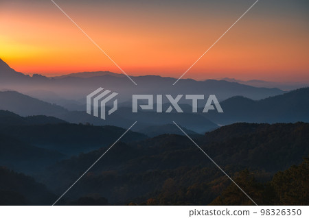 Scenery of sunrise over Doi Kham Fah mountain peak with foggy in tropical rainforest at national park, Chiang Dao, Chiang Mai 98326350