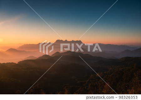 Scenery of sunrise over Doi Kham Fah mountain peak with foggy in tropical rainforest at national park, Chiang Dao, Chiang Mai 98326353