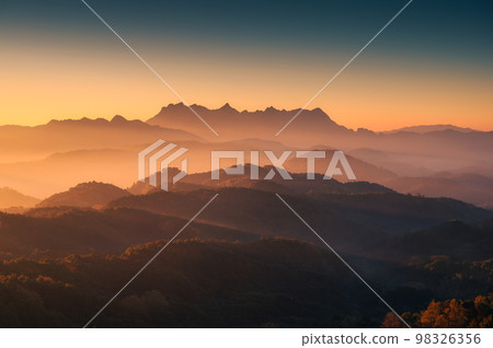 Scenery of sunrise over Doi Kham Fah mountain peak with foggy in tropical rainforest at national park, Chiang Dao, Chiang Mai 98326356