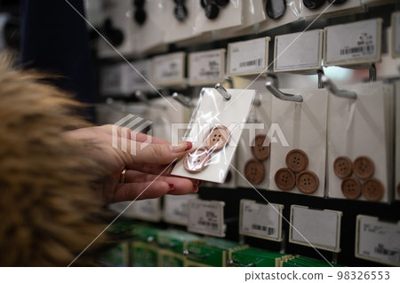 Woman's hand choosing a button 98326553