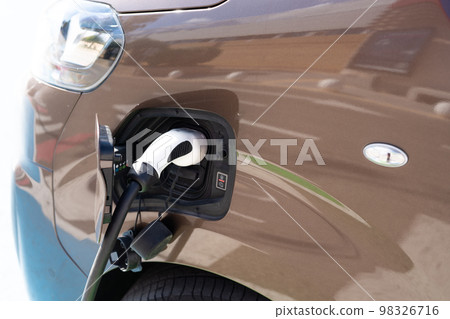 Charging station for a car close-up. Green energy, environmentally friendly car. Charging station for a car close-up. Green energy, environmentally friendly car. 98326716