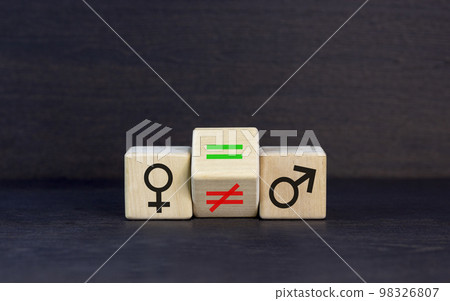 Symbol for gender equality. Turned a cube and changed a unequal sign to a equal sign between symbols of men and women. Beautiful black table black background, copy space. Gender equality concept. 98326807