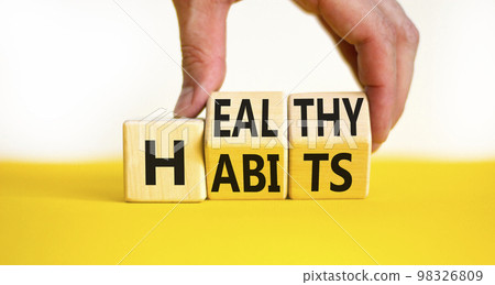 Healthy habits symbol. Concept words Healthy habits on wooden cubes. Doctor hand. Beautiful yellow table white background. Medical and healthy habits concept. Copy space. 98326809