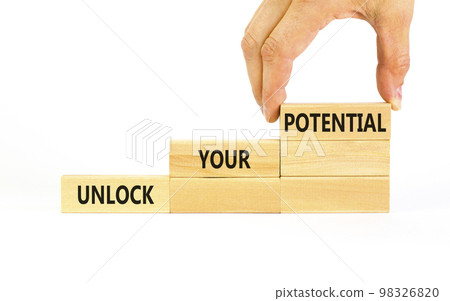 Unlock your potential symbol. Concept words Unlock your potential on wooden blocks. Businessman hand. Beautiful white background. Business, psychological unlock your potential concept. Copy space. 98326820