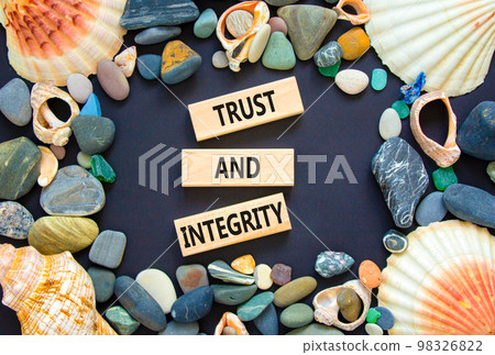 Trust and integrity symbol. Concept words Trust and integrity on wooden blocks. Sea stone, seashell. Beautiful black background. Business, psychological and trust and integrity concept. Copy space. Trust and integrity symbol. Concept words Trust and integrity on wooden blocks. Sea stone, seashell. Beautiful black background. Business, psychological and trust and integrity concept. Copy space. 98326822