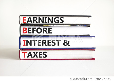 EBIT symbol. Concept words EBIT earnings before interest and taxes on books on beautiful white background. Businessman hand. Business EBIT earnings before interest and taxes concept. Copy space 98326850