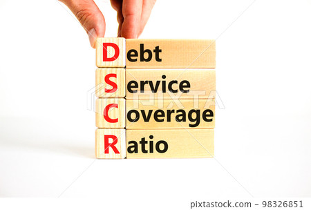 DSCR debt service coverage ratio symbol. Concept words DSCR debt service coverage ratio on wooden block on beautiful white background. Business DSCR debt service coverage ratio concept. Copy space. DSCR debt service coverage ratio symbol. Concept words DSCR debt service coverage ratio on wooden block on beautiful white background. Business DSCR debt service coverage ratio concept. Copy space. 98326851